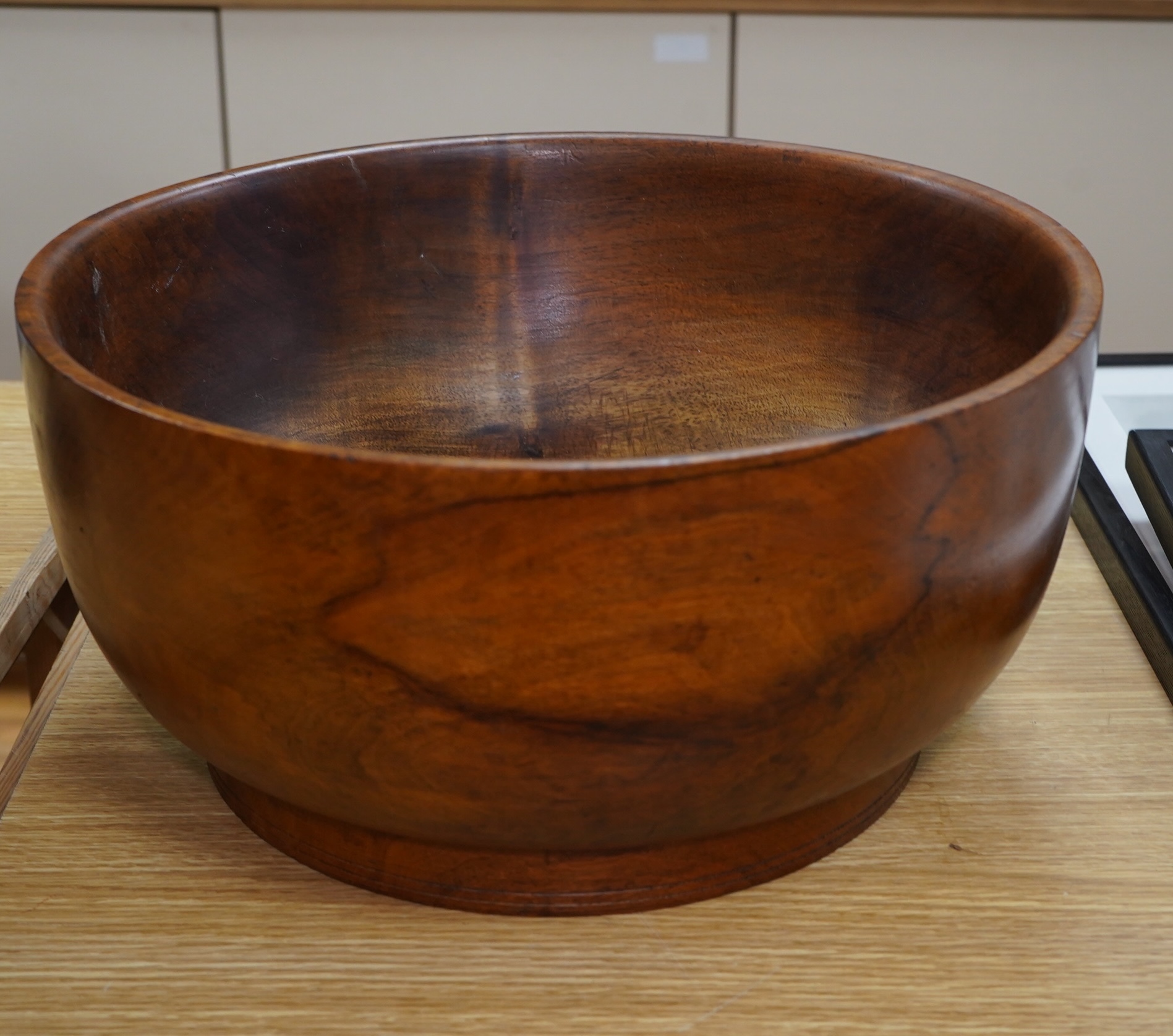 A large turned walnut bowl, carved from the solid, 38cm diameter. Condition - good